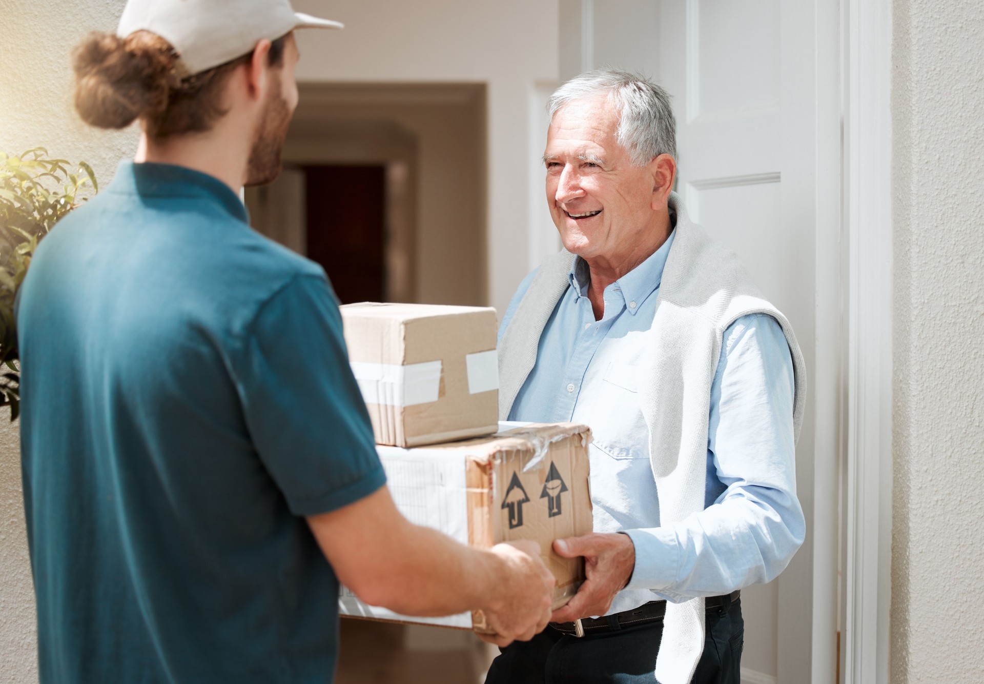 Shot of a senior man receiving his delivery from the courier